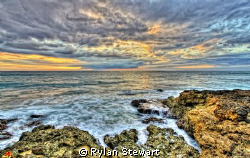 The sunset off of Makaha Hawaii. by Rylan Stewart 